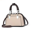Close-up of beige lychee texture leather handbag with brown handles and silver hardware - Light Khaki