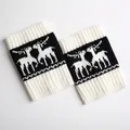 Detailed view of knitted Christmas leg warmers with white reindeer jacquard on black base - White/Black
