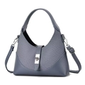 Detail of grey-blue patchwork hobo bag with silver turn-lock and denim texture - Blue