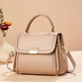 Detailed close-up of light brown leather tote bag with gold buckle and dry flower decor - Khaki