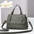 Detail of dark grey lychee pattern leather handbag with elegant gold metal hardware - Gray