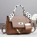 Detail of brown faux leather handbag with woven texture flap and scarf wrapped handle - Brown