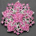 Macro detail of a silver floral brooch encrusted with vibrant pink rhinestones and crystals - Pink