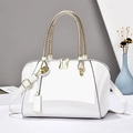 White patent leather Boston handbag with metallic woven handles and gold-tone hardware - White