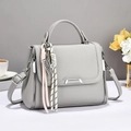 Elegant light gray lychee grain leather handbag with abacus charm and crossbody strap - Gray