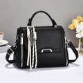Classic black litchi pattern leather handbag with adjustable strap and woven charms - Black
