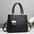Minimalist black lychee texture handbag with silver hardware and a mini charm - Black