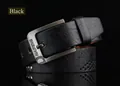 Macro detail of men's vintage leather belt with gunmetal buckle and textured rivets - 110cm / Black