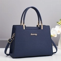 Close-up of textured deep blue tote bag featuring polished gold hardware and logo - Black