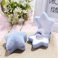 Star-shaped light blue velvet jewelry box with sapphire ring on textured base - Blue Starfish