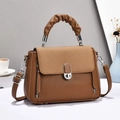 Brown leather crossbody handbag with woven texture and top handle in a lifestyle setting - Earthy Yellow