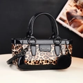 Leopard print handbag with shiny black patent leather and fuzzy pom pom charm - Orange
