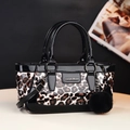 Glossy leopard print handbag with black patent leather trim and plush pom-pom charm - Coffee