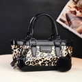 Chic leopard print crossbody handbag with black patent leather trim and a pompom charm - Yellow