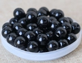 Macro detail of polished black round beads with center holes for DIY jewelry making - 8mm / Black