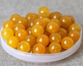 Macro shot of polished yellow natural jade beads for DIY jewelry and handicraft making - 8mm / Yellow