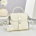 Detail of lychee pattern leather handbag with silver hardware and mini bag charm - Off-white