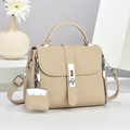 Chic beige pebbled PU leather mini crossbody bag with silver hardware on a display stand - Khaki