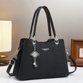 Black leather macaron handbag with textured finish and elegant pearl charm pendant - Black