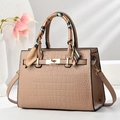 Detail of light brown croc-embossed tote bag with golden twist lock and printed scarf - Khaki