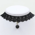 Gothic black lace floral choker featuring a polished round black bead pendant on a white neck - Lace Trim Black Bead (1476)