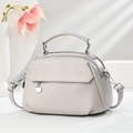 Light gray litchi texture handbag with double zipper compartments and a round metal charm - Light Gray