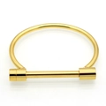 Detailed close-up of golden stainless steel horseshoe U-shape buckle bangle bracelet - Gold