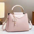 Pink canvas texture tote bag with golden handle and diamond C-pendant in a home setting - Pink