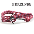 Macro shot of burgundy rope bracelet with silver anchor clasp featuring Vikings engraving - Burgundy