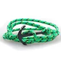 Macro detail of nautical braided paracord bracelet with black metallic anchor clasp - Green/Black