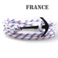 Macro detail of the tricolor braided nautical rope with a black metal anchor buckle - White/Red/Blue