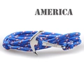 Detail of nautical braided nylon bracelet featuring a silver Viking anchor clasp - Blue White and Red