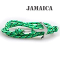Close-up of green and yellow nylon braided bracelet with a silver anchor clasp - Green and Yellow