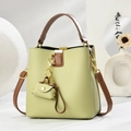 Detail of avocado green litchi texture bucket bag with brown handles and golden hardware - Mint Green