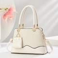 Elegant cream beige woven handbag with gold hardware and stylish mini bag charm - Off White