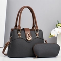 Detail of woven texture handbag with brown leather handles and golden metal clasp - Black