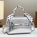 Detail of silver crocodile pattern bag with polka dot scarf and golden metal lock - Silver / L22 W10 H16