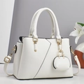 Elegant ivory faux leather handbag with gold accents and a matching charm pendant - White