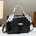 Elegant black crocodile pattern handbag with polka dot scarf handle and golden hardware - Black