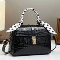 Elegant black crocodile embossed crossbody bag with polka dot scarf on top handle - Black