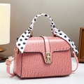 Pink stone pattern handbag with crocodile texture, gold lock, and polka dot scarf detail - Pink