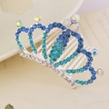 Close-up of a silver crown hair comb featuring blue and iridescent colorful rhinestones - Style 1 Blue