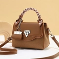 Detail of brown patchwork handbag with scarf-wrapped handle and silver metallic clasp - Khaki/Earth Yellow