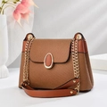 Brown woven crossbody bag with gold chain strap and leather details on white background - Earthy Yellow
