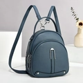 Grey-blue faux leather backpack with pebble texture and adjustable straps on white stand - Blue