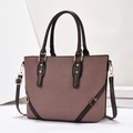 Detail of a brown textured tote bag featuring gold hardware and contrast leather trim - Coffee