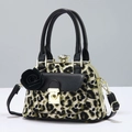 Detailed close-up of leopard print canvas bag with black leather flap and metal clasp - Teal Leopard Print