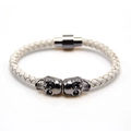 Macro detail of braided leather bracelet with twin skulls and magnetic clasp closure - Gun Black and White