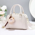 Elegant cream Boston bag in pebble PU leather with jacquard strap and plush cat charm - White
