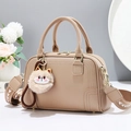 Elegant beige pebbled leather Boston bag with cat pendant and geometric wide strap - Khaki